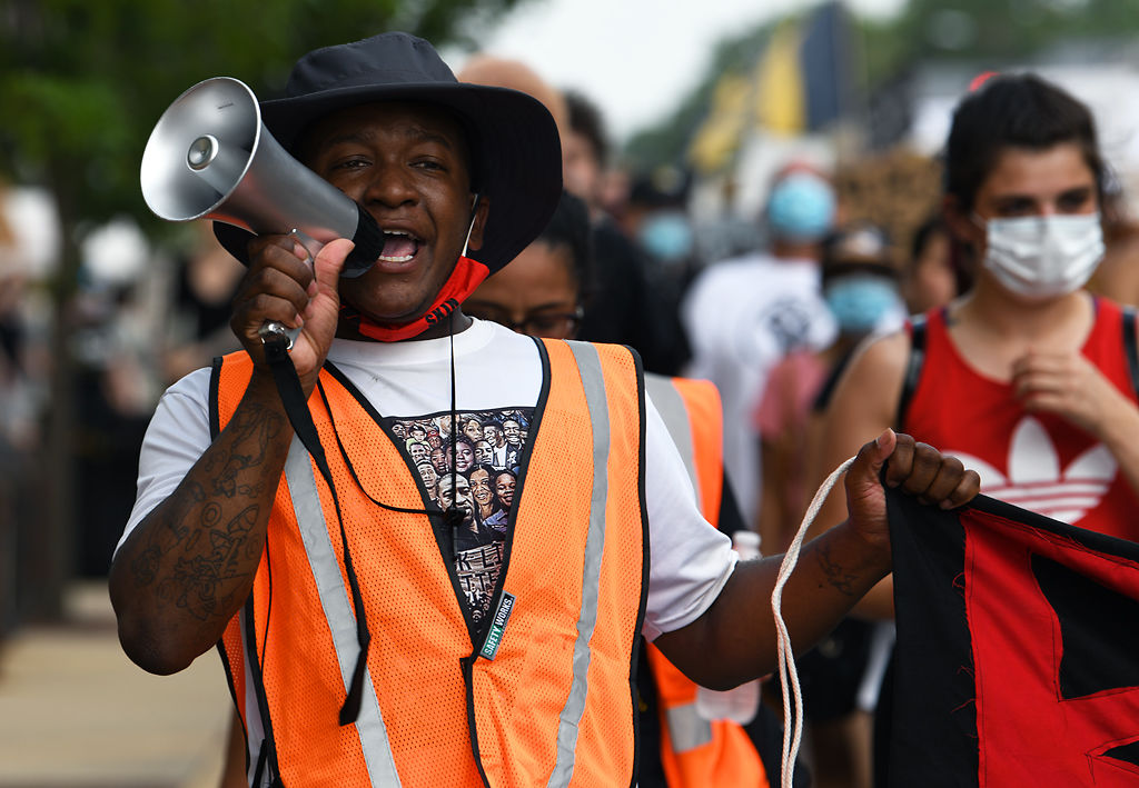 Markiez Smith leads marchers from the Boone County Courthouse down Eighth Street